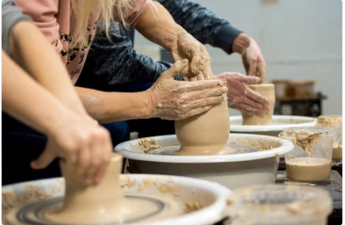 beginners wheel throwing class sydney students shaping clay on pottery wheel
