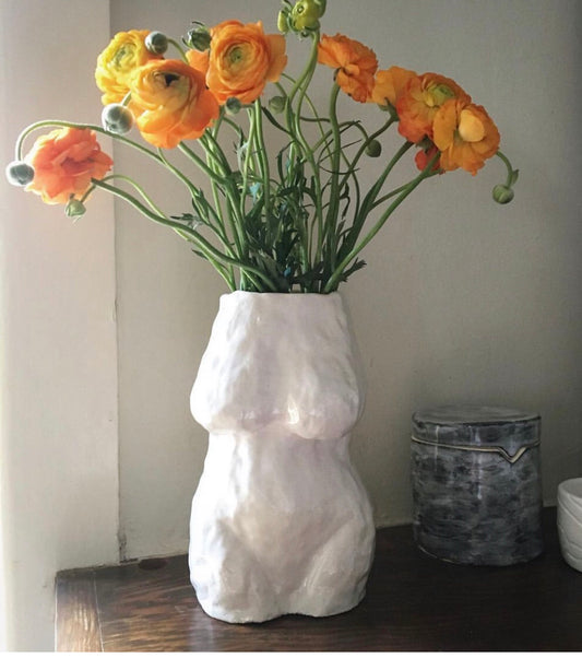 torso vase with bright flowers